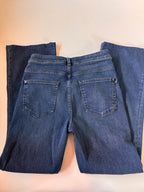 Pair of blue jeans on a beige background