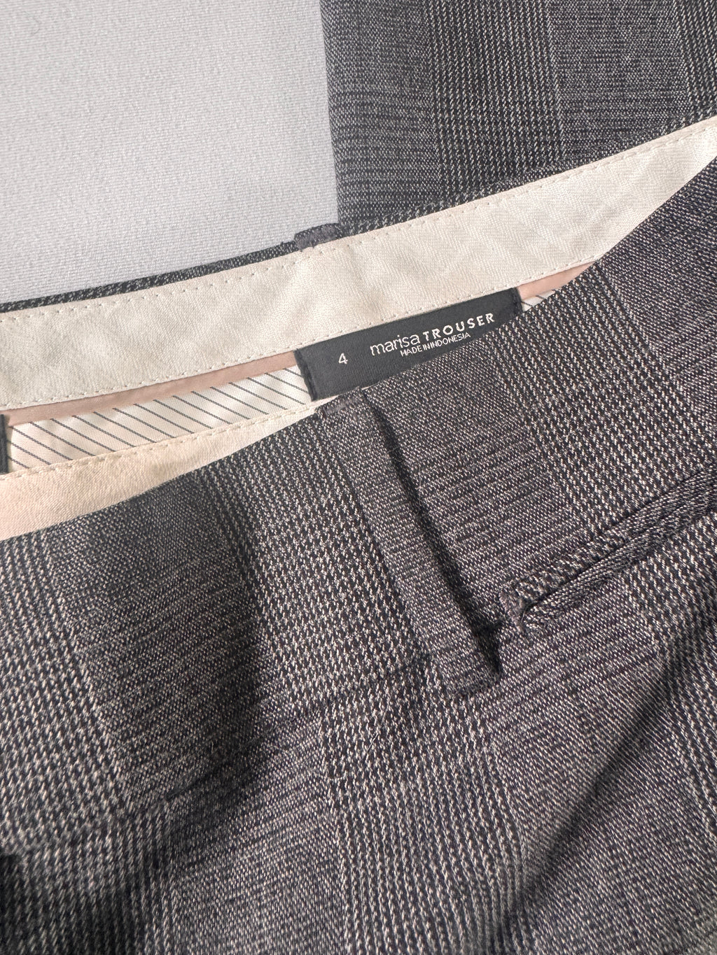 Close-up of a gray textured fabric with a brand label.