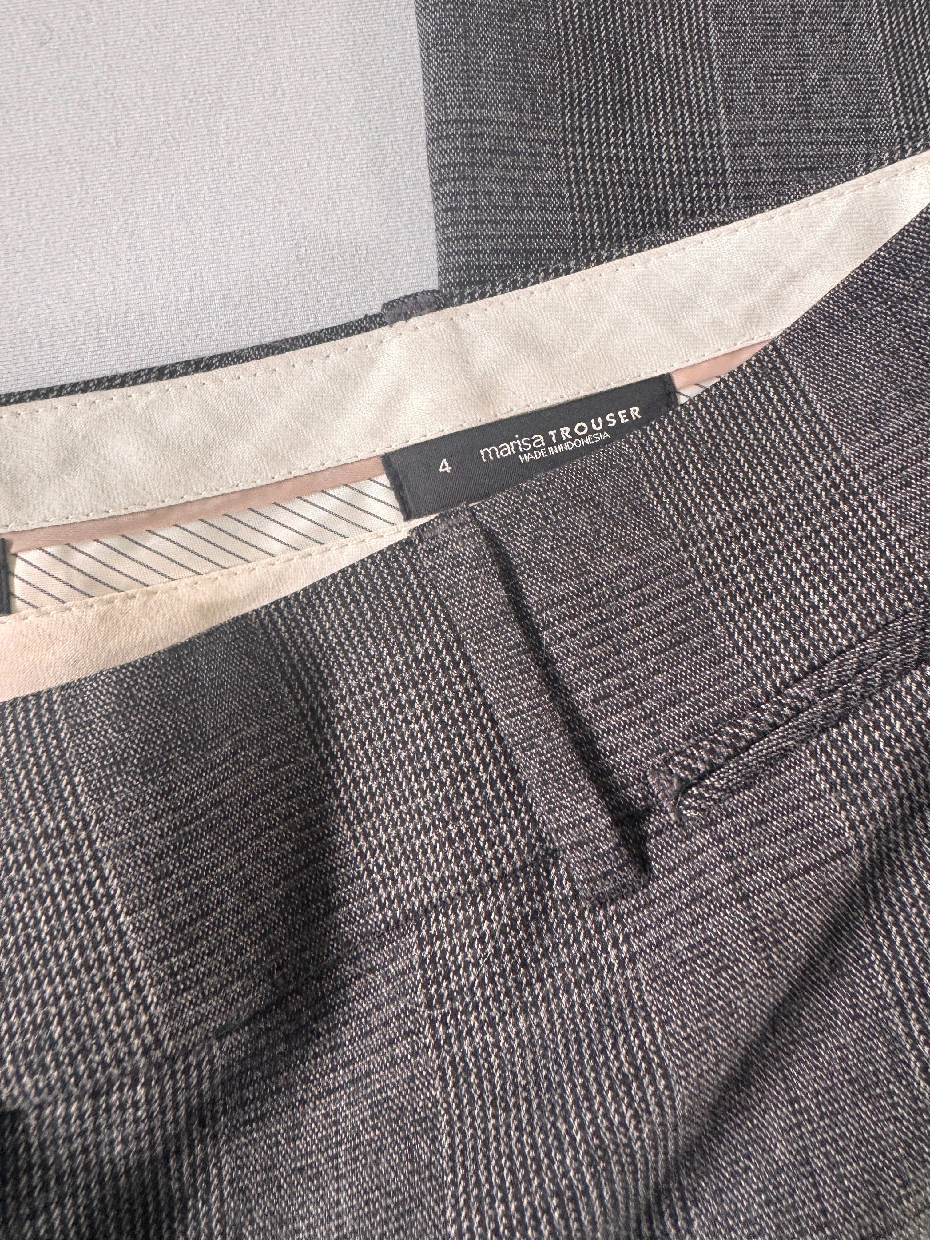 Close-up of a gray textured fabric with a brand label.