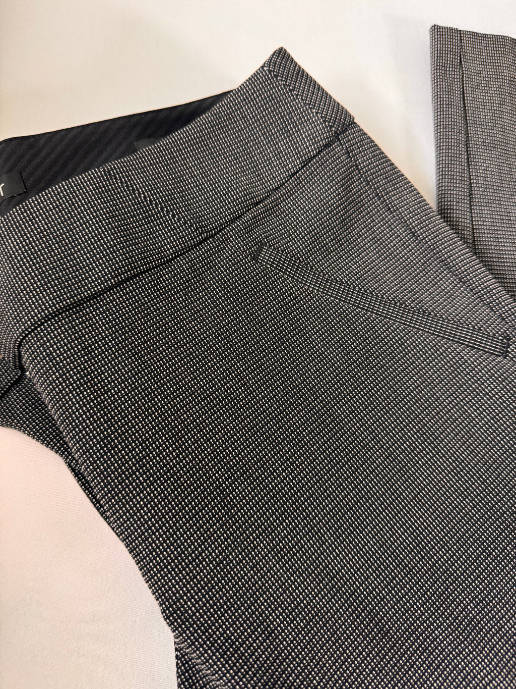 Gray checkered pants on a light beige surface