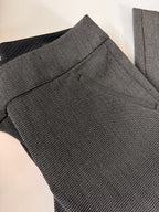 Gray checkered pants on a light beige surface
