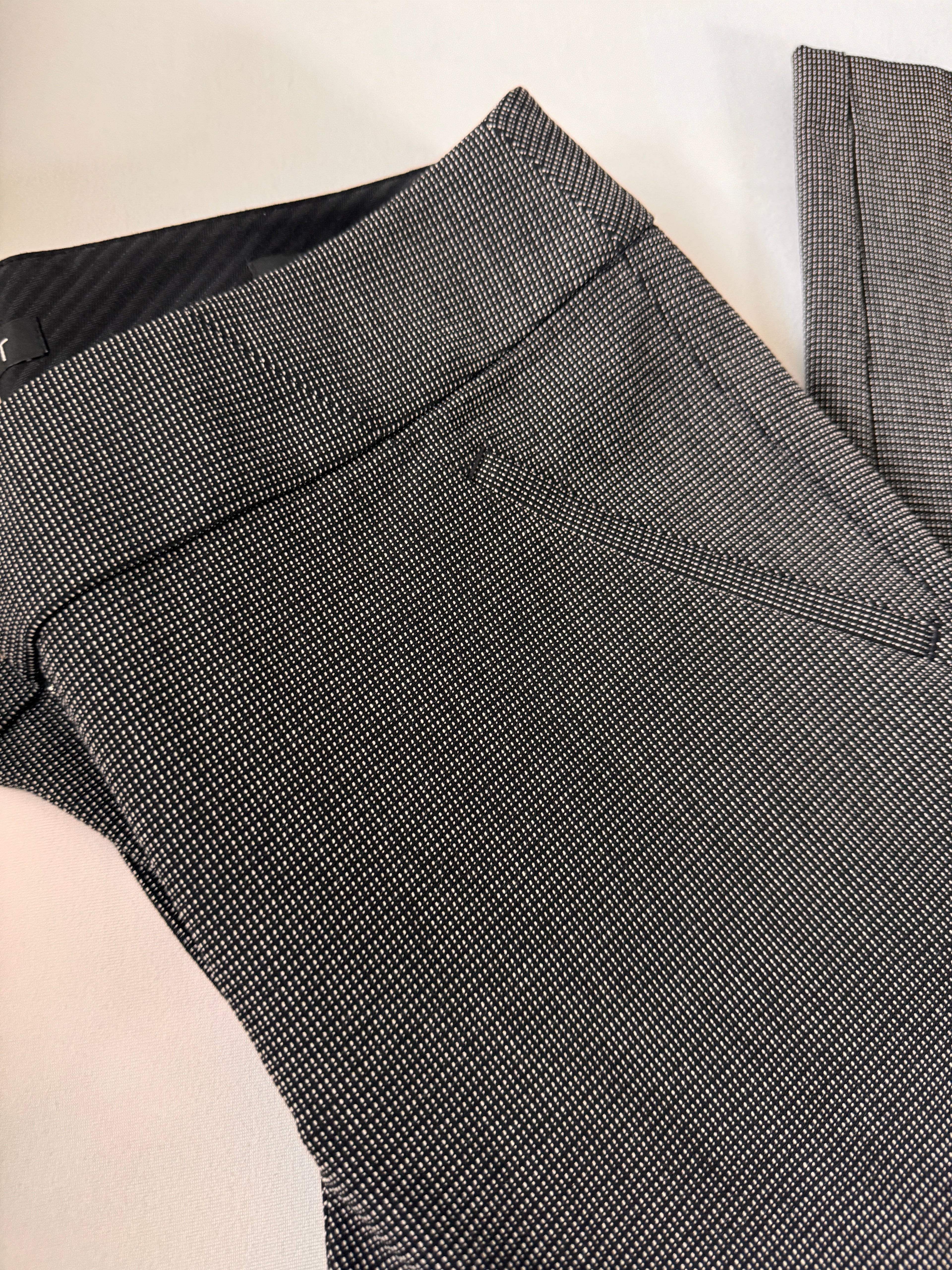 Gray checkered pants on a light beige surface