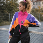 Woman wearing a colorful tracksuit on a tennis court