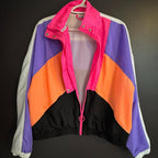 Colorful jacket with pink, purple, orange, and black sections on a dark background