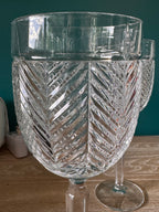 Clear glass vase with intricate patterns on a wooden surface