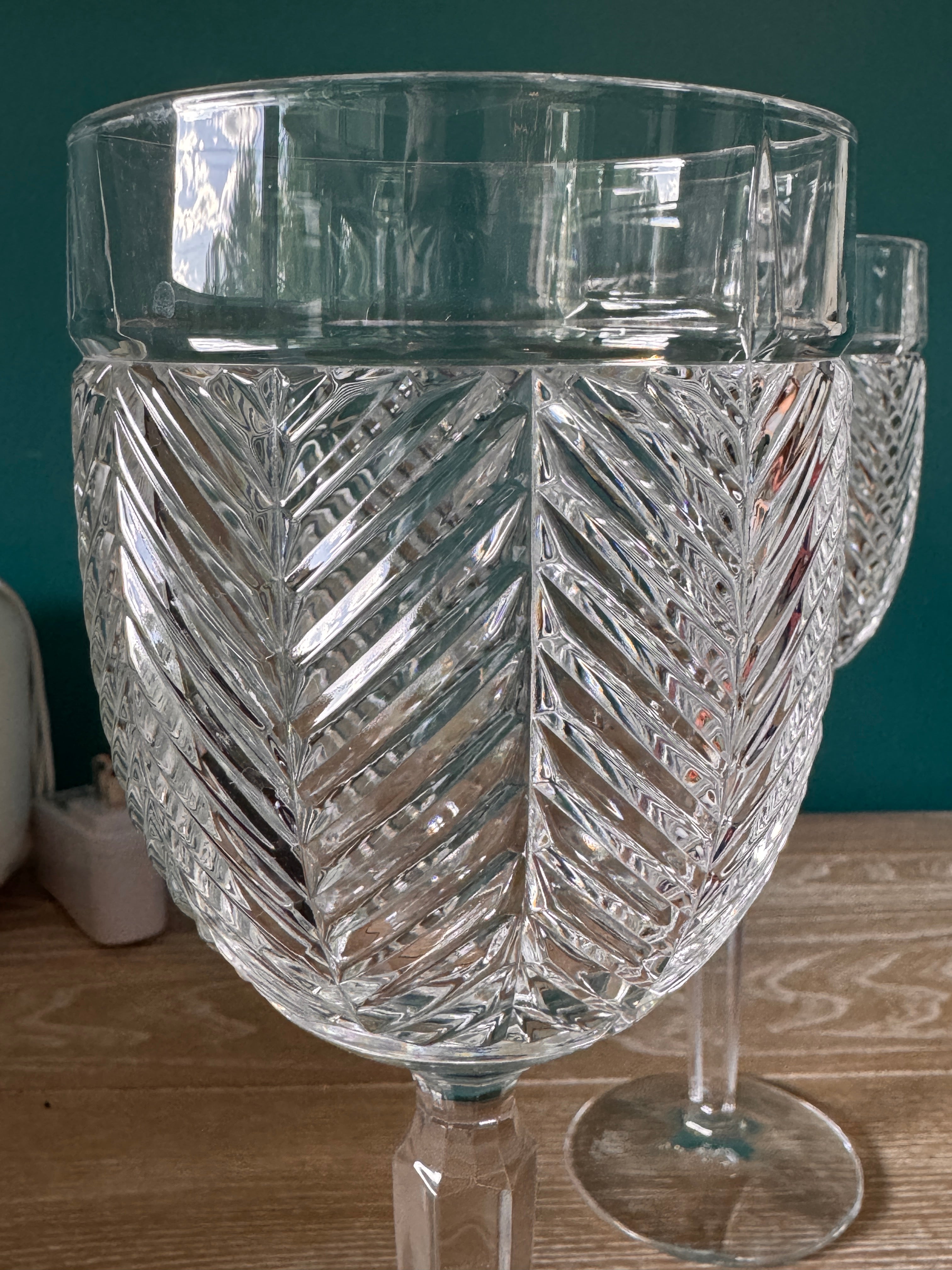 Clear glass vase with intricate patterns on a wooden surface