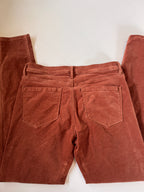 Brown pants laid flat on a white background