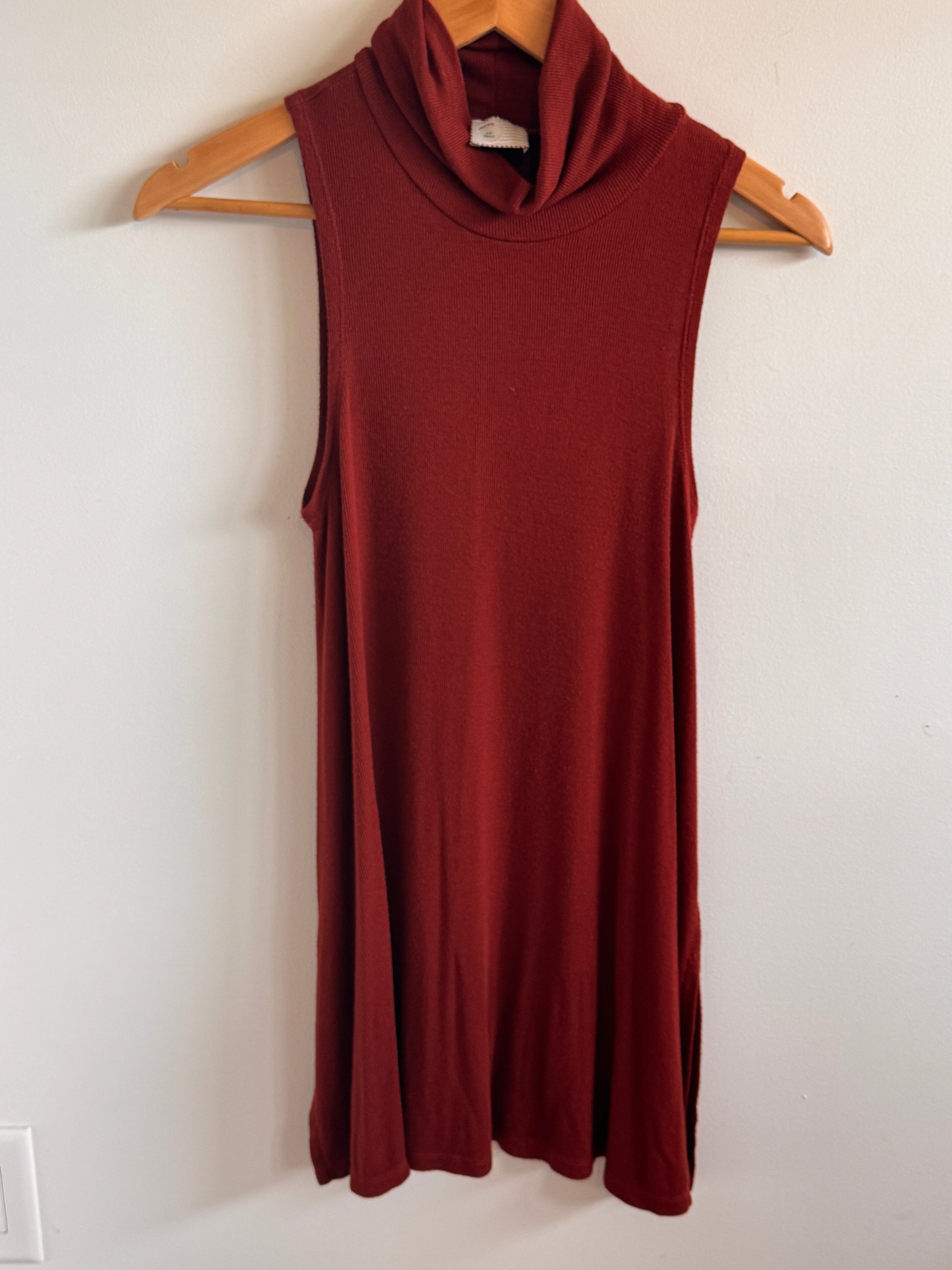 Rust Top on a hanger against a white wall