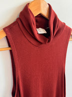 Red garment on a wooden hanger against a white background