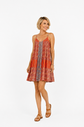 Woman wearing a patterned dress on a white background