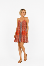 Woman wearing a patterned dress on a white background