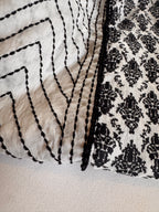 Close-up of a black and white patterned fabric with geometric design.