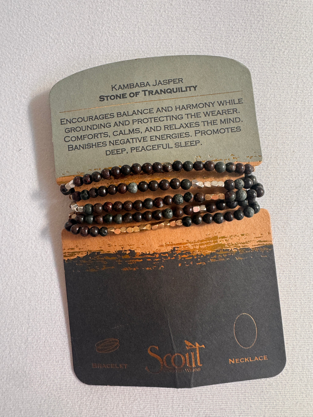 Set of black beaded bracelets on a Scott branded card with text