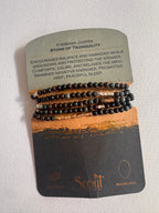 Set of black beaded bracelets on a Scott branded card with text