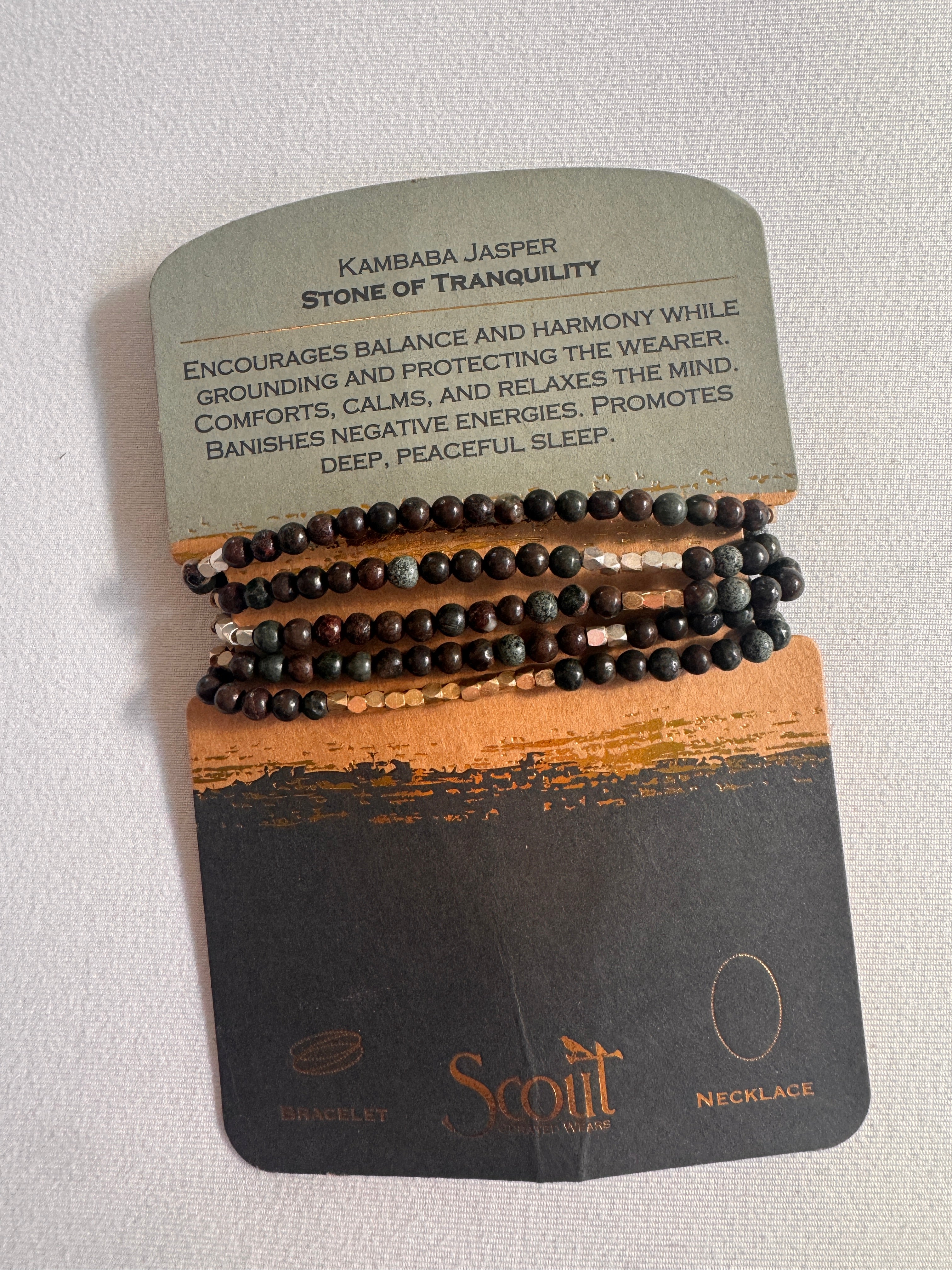 Set of black beaded bracelets on a Scott branded card with text