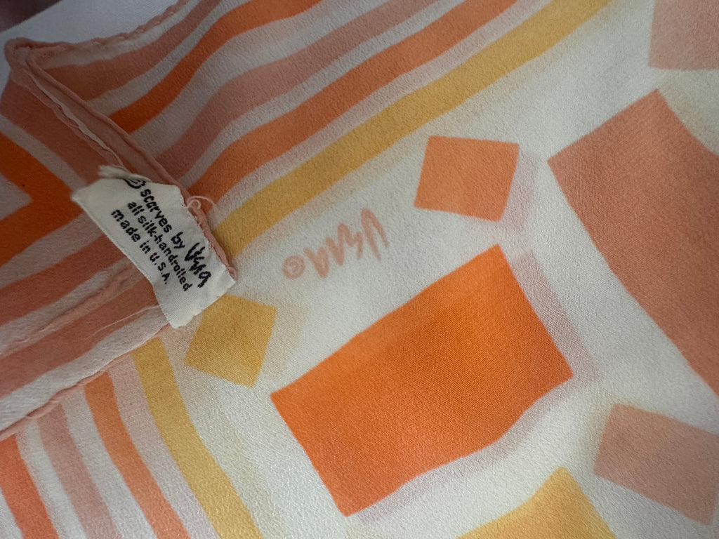Close-up of a fabric with geometric patterns and a visible brand tag.