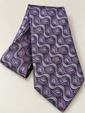 A purple and silver paisley patterned necktie, folded to show its texture and pattern, set against a plain light beige background.