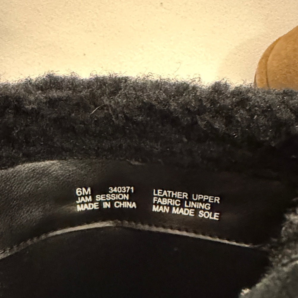Close-up of a shoe label with text on a beige background