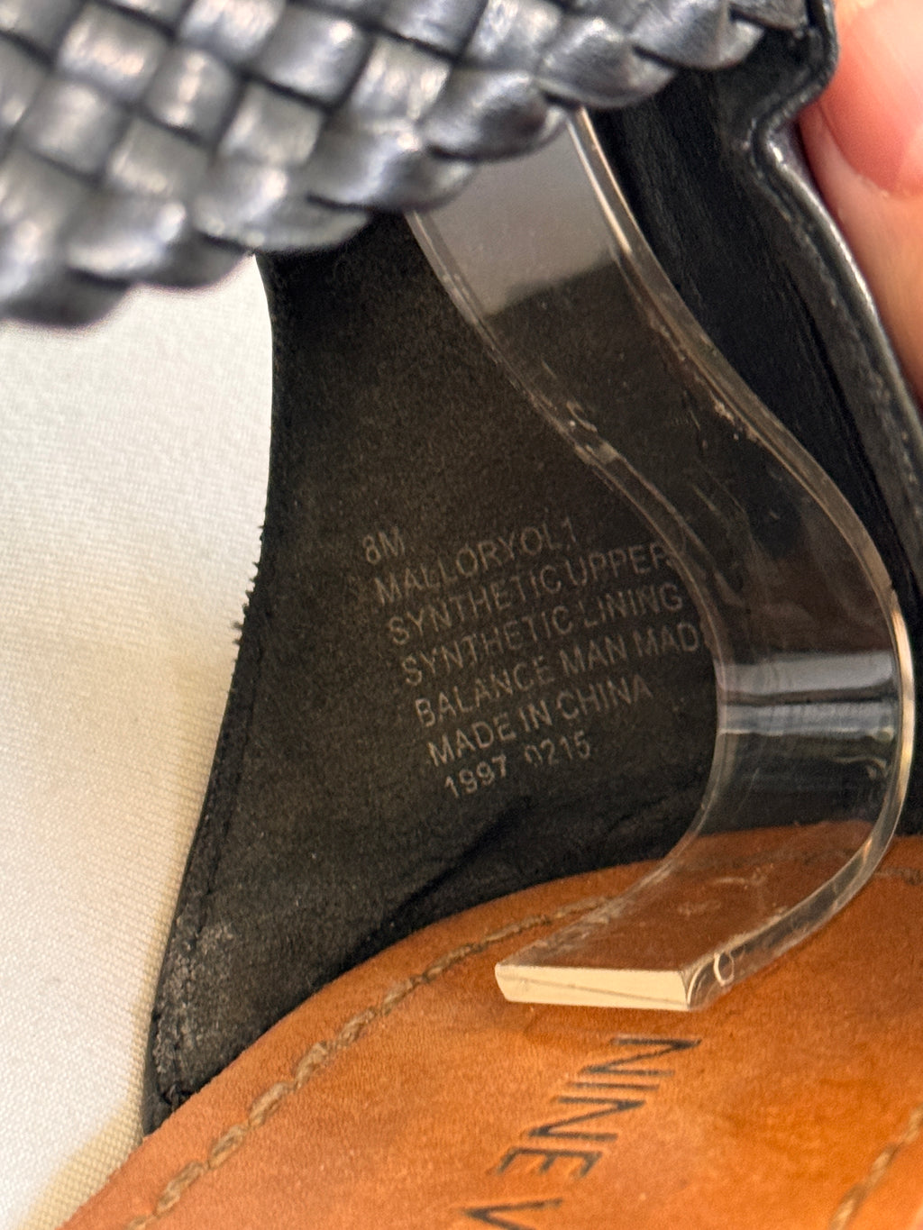 Label inside of black leather sandals