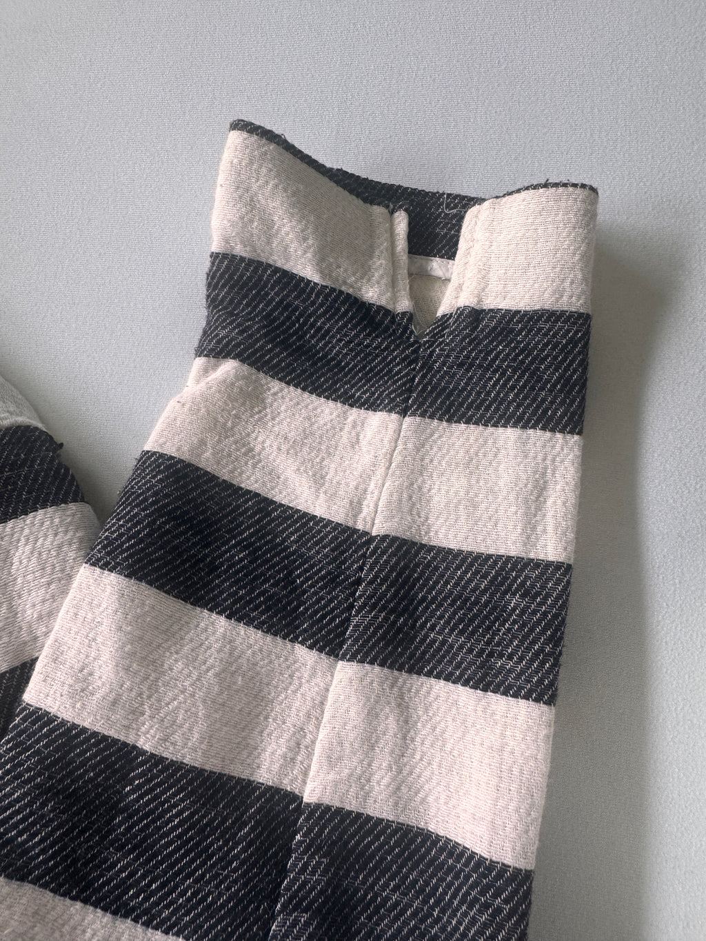 Black and white striped fabric on a gray background