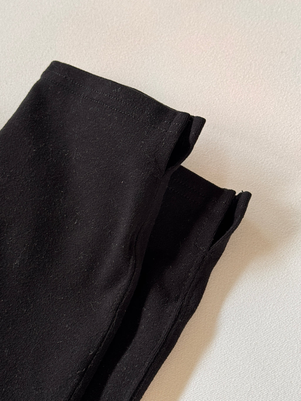 Close-up of black fabric on a light beige background