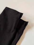 Close-up of black fabric on a light beige background