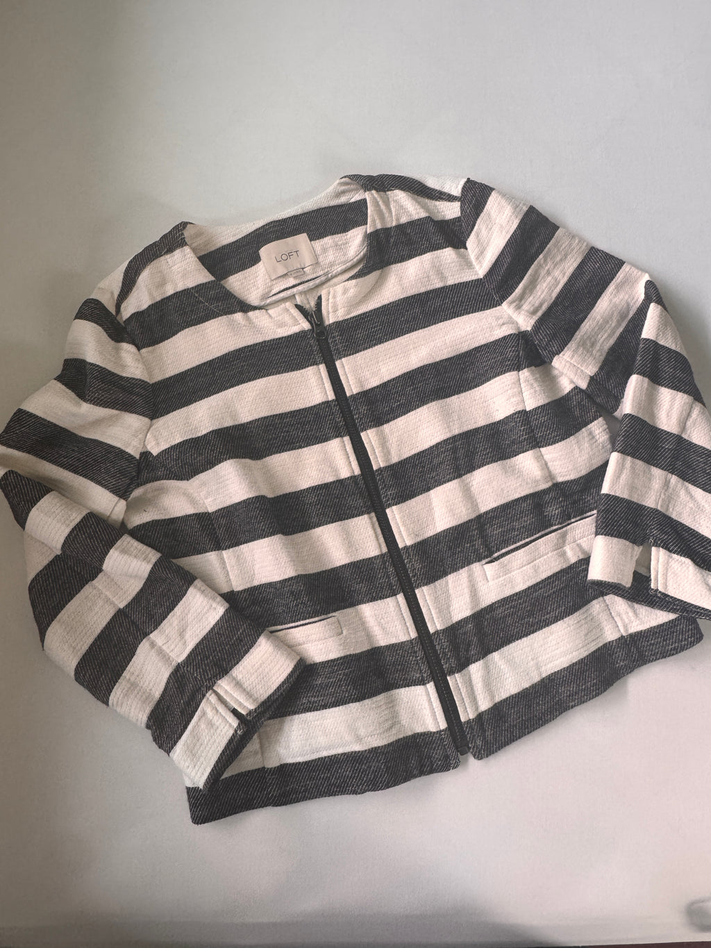 Black and white striped fabric on a light gray background
