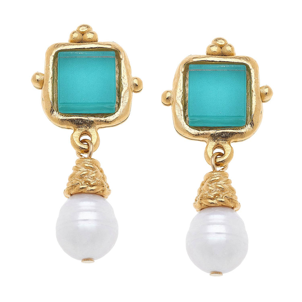 Gold earrings with turquoise square stones and white pearls on a white background
