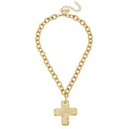Gold chain necklace with a cross pendant on a white background