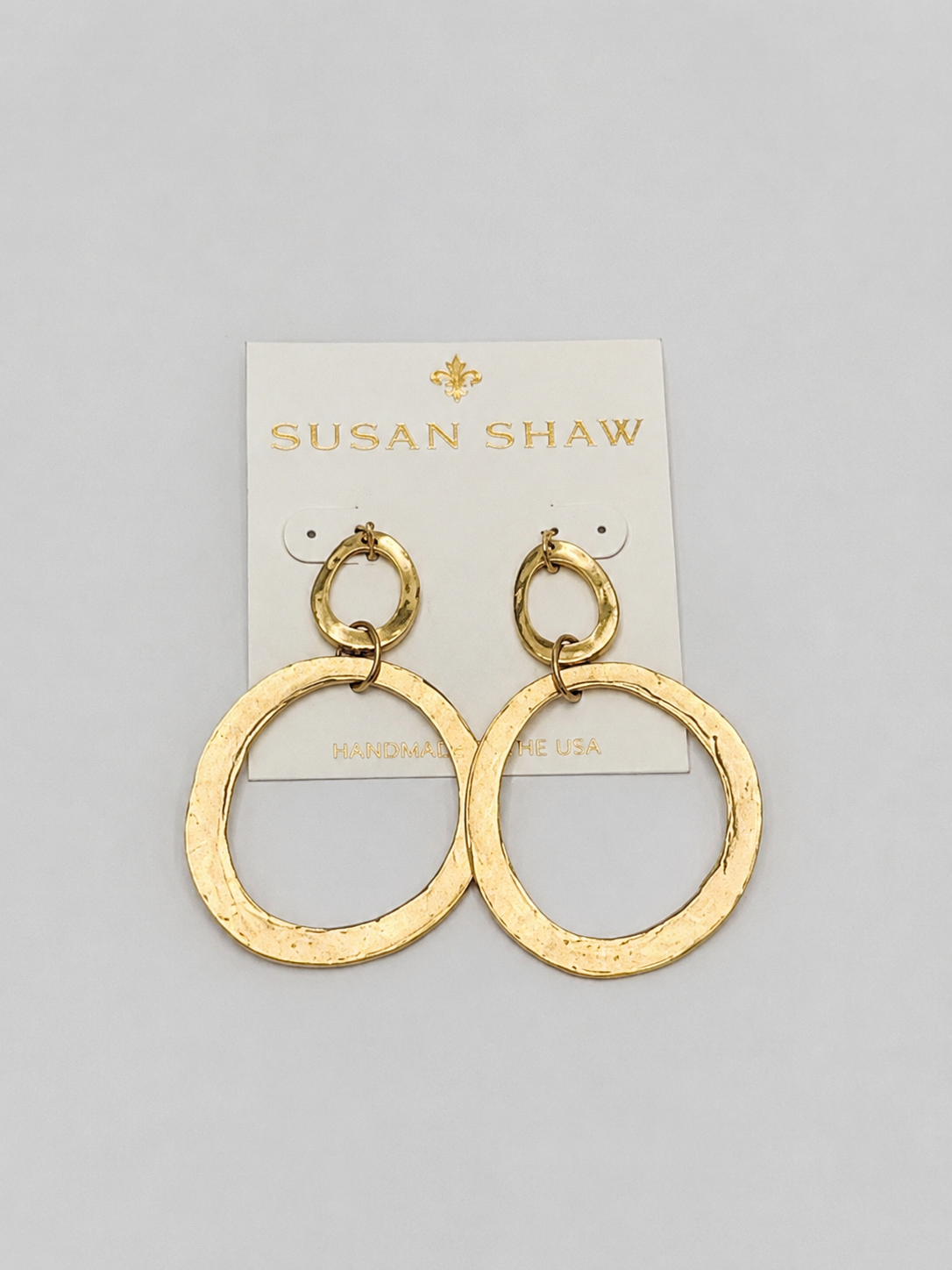 Gold hoop earrings on a Susan Shaw branded card against a white background