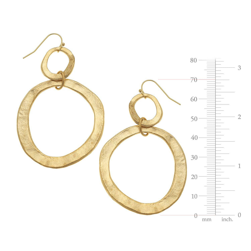 Gold hoop earrings with a measurement scale on a white background