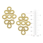 Gold earrings with intricate design and a measurement scale on a white background