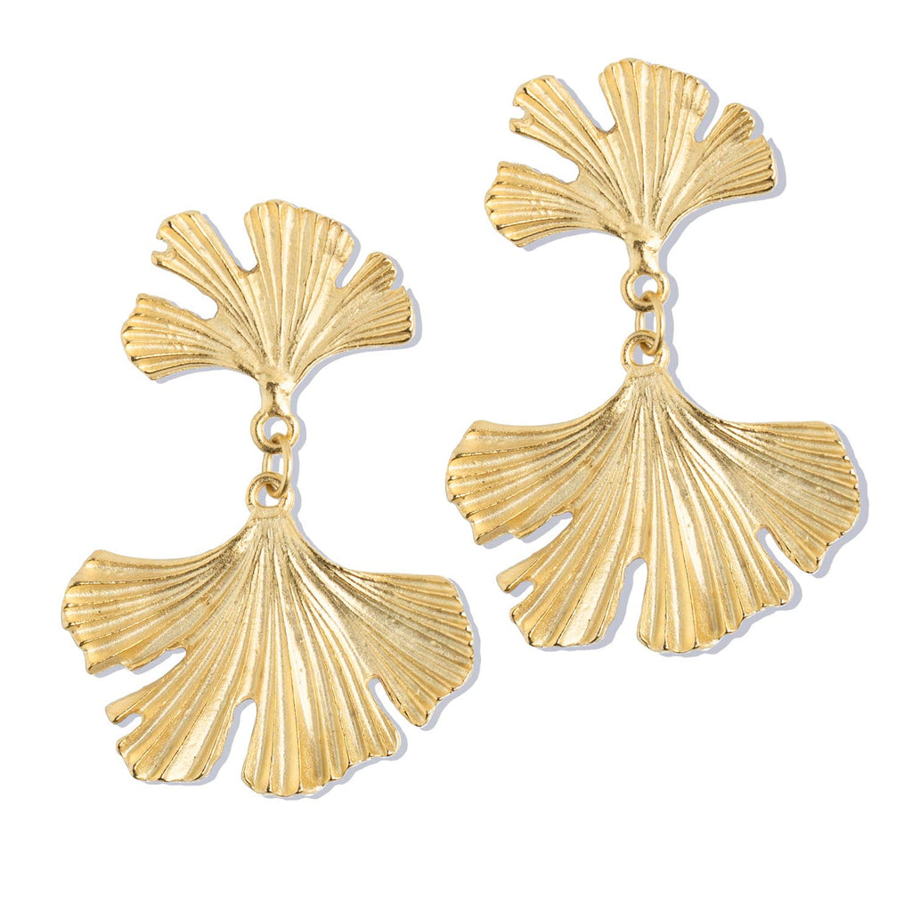 Gold leaf-shaped earrings on a white background