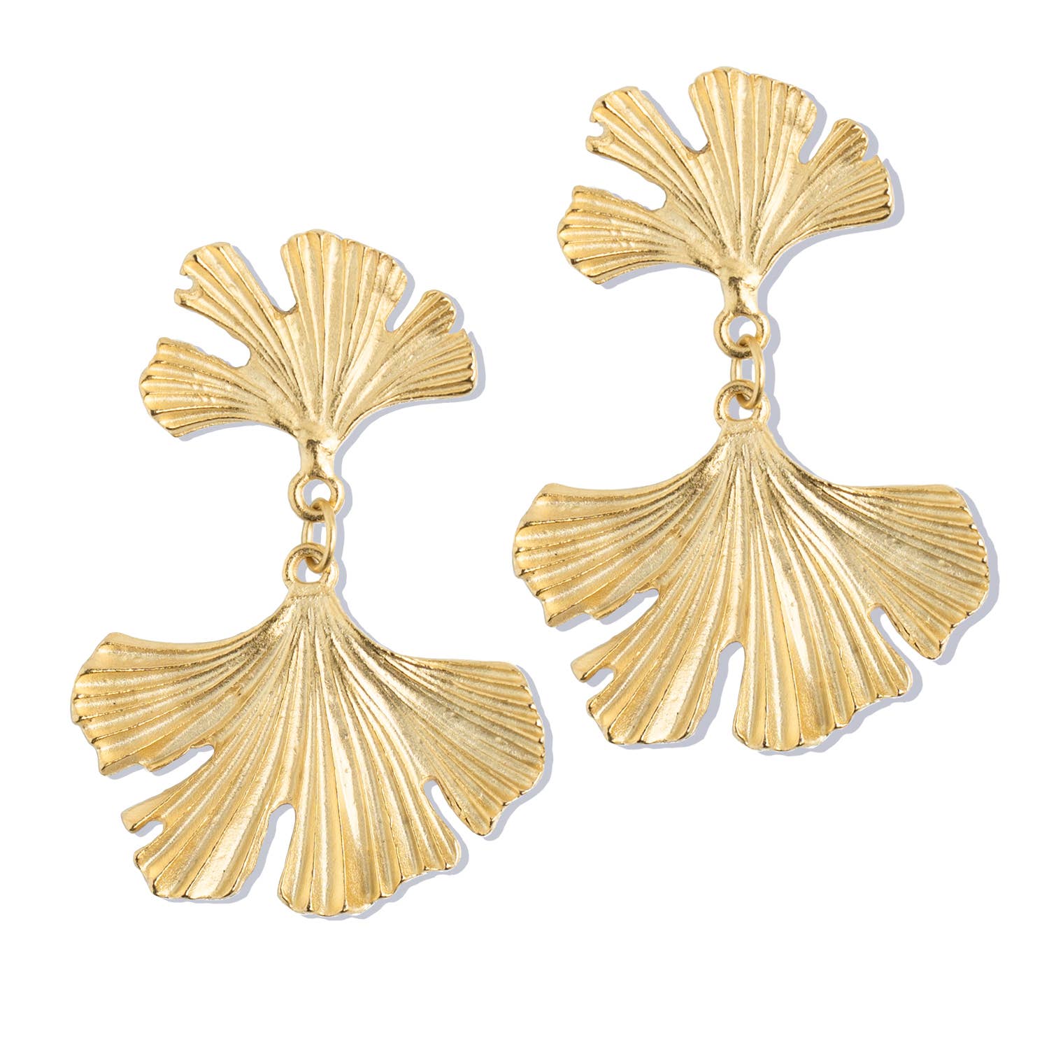 Gold leaf-shaped earrings on a white background