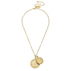 Gold necklace with two round pendants on a white background