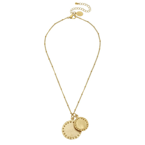 Gold necklace with two round pendants on a white background