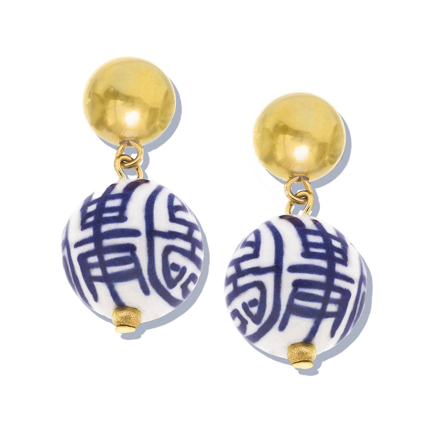 Earrings with gold tops and blue and white patterned balls on a white background