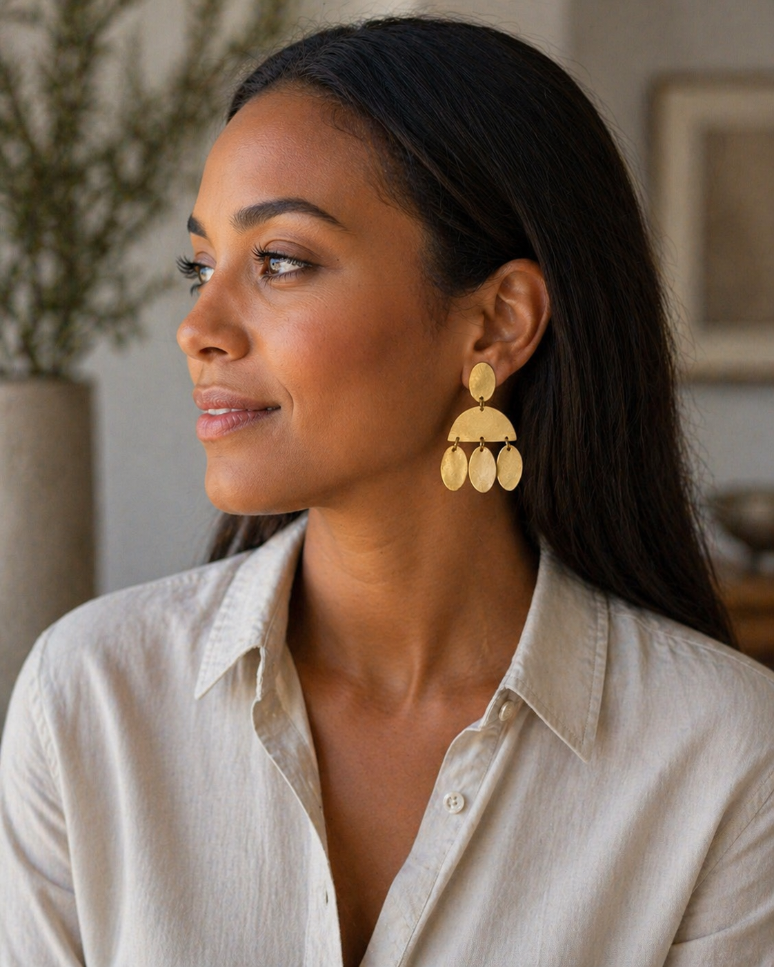 Woman wearing gold earrings in a casual setting