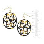 Black and gold earrings with a measurement scale on a white background