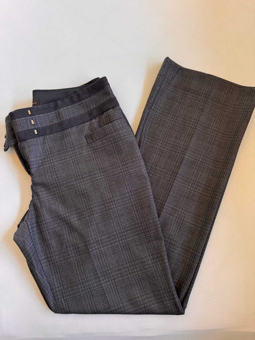 Folded plaid pants on a light colored background