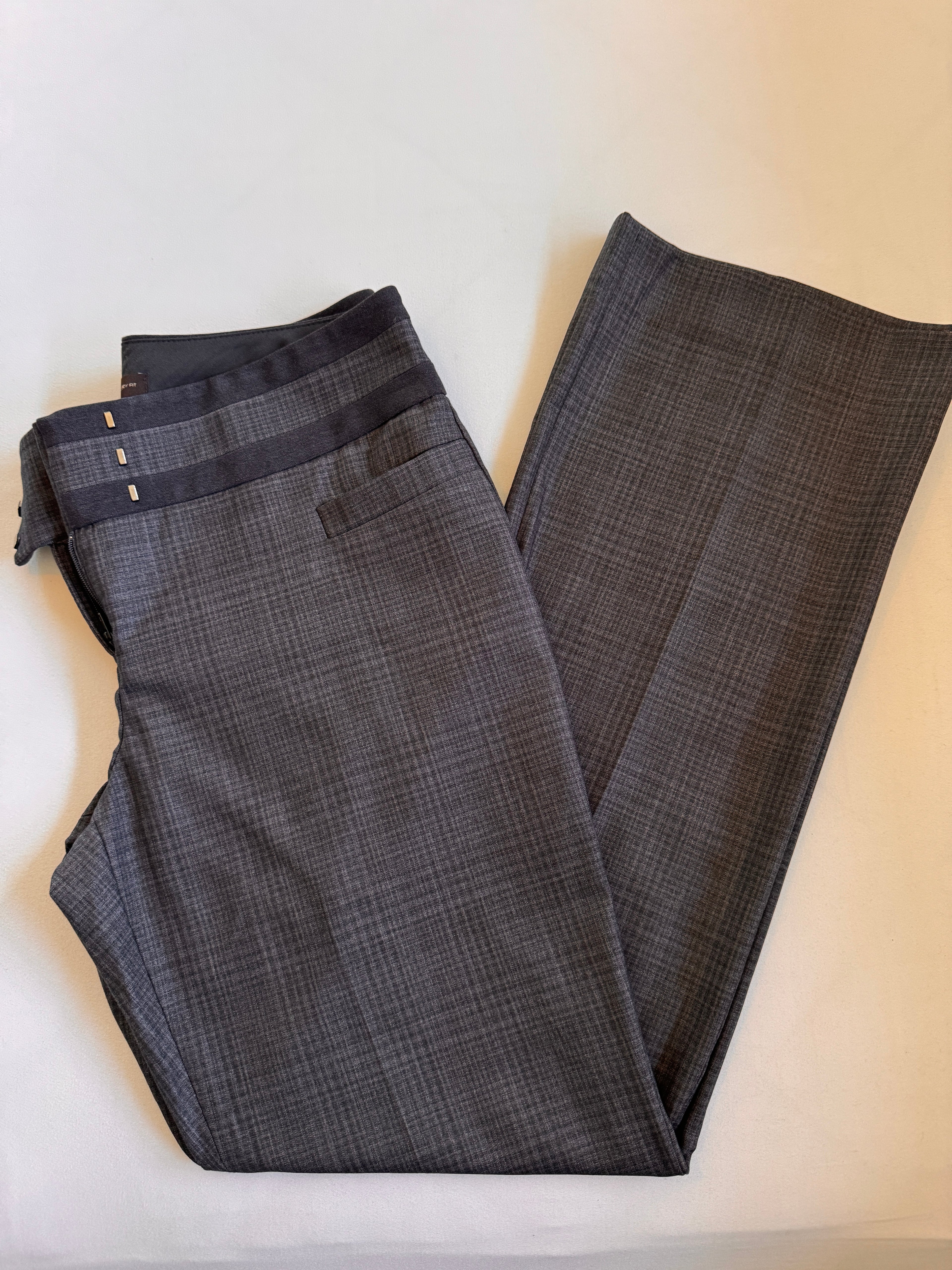 Folded plaid pants on a light colored background