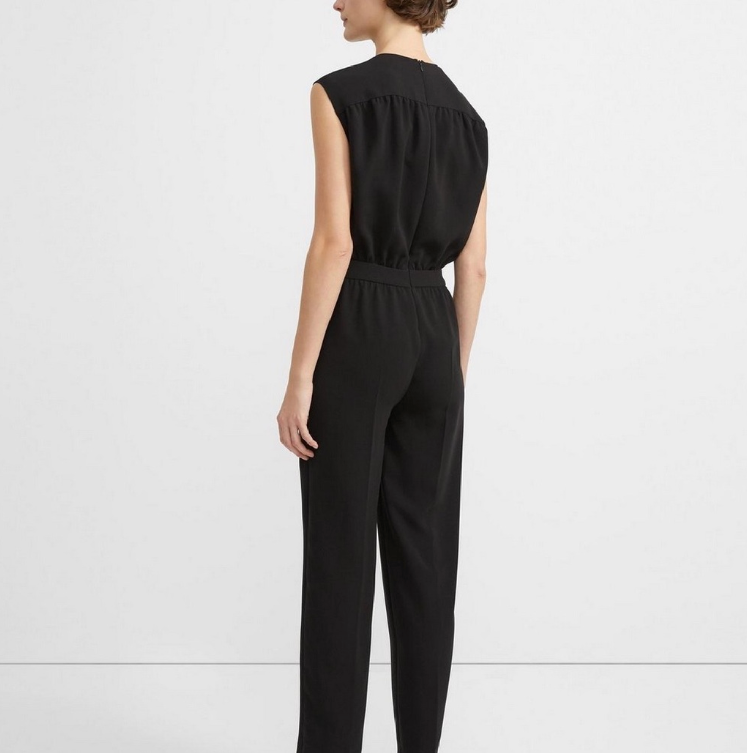 Person wearing a black jumpsuit on a white background