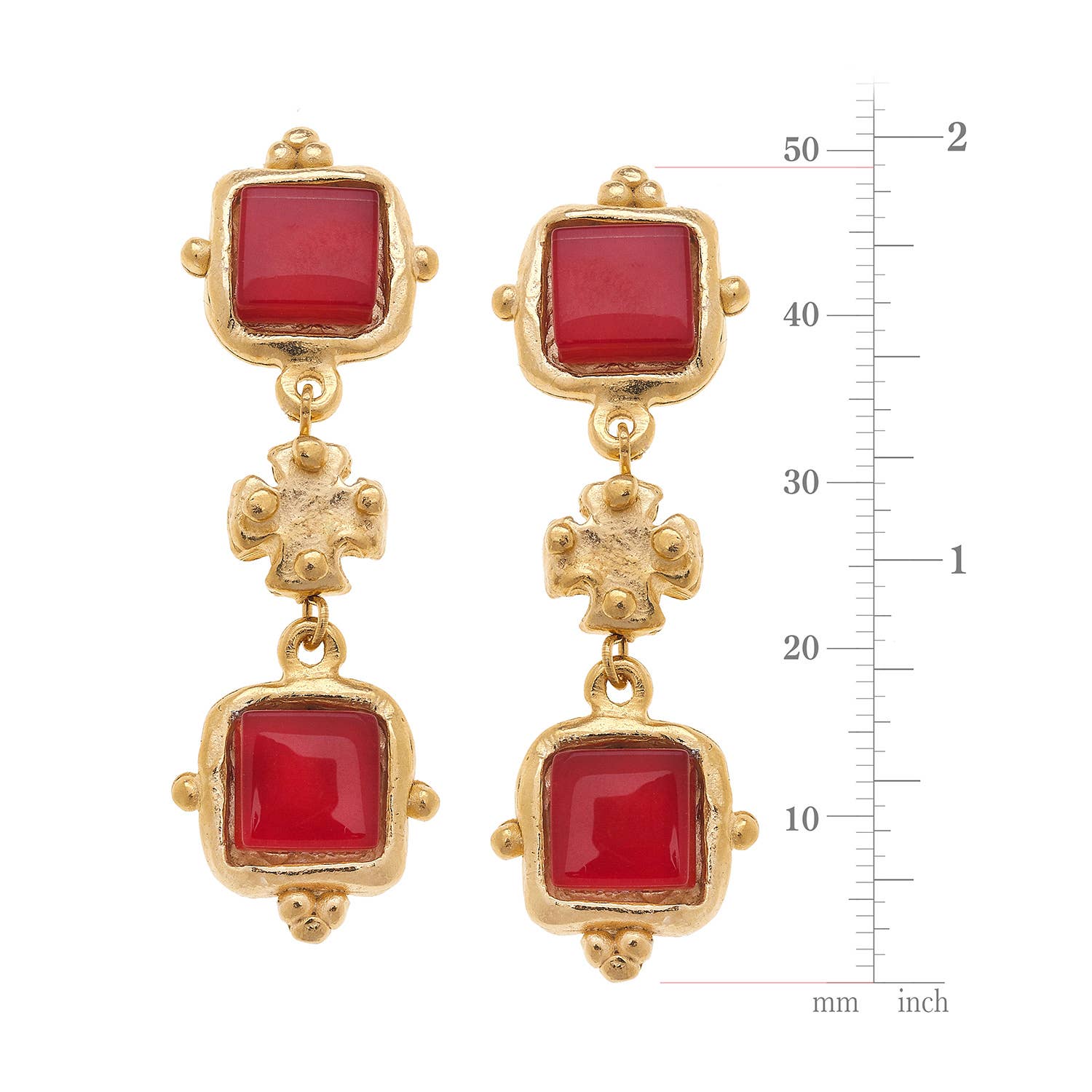 Gold earrings with red stones on a white background with measurement scale.