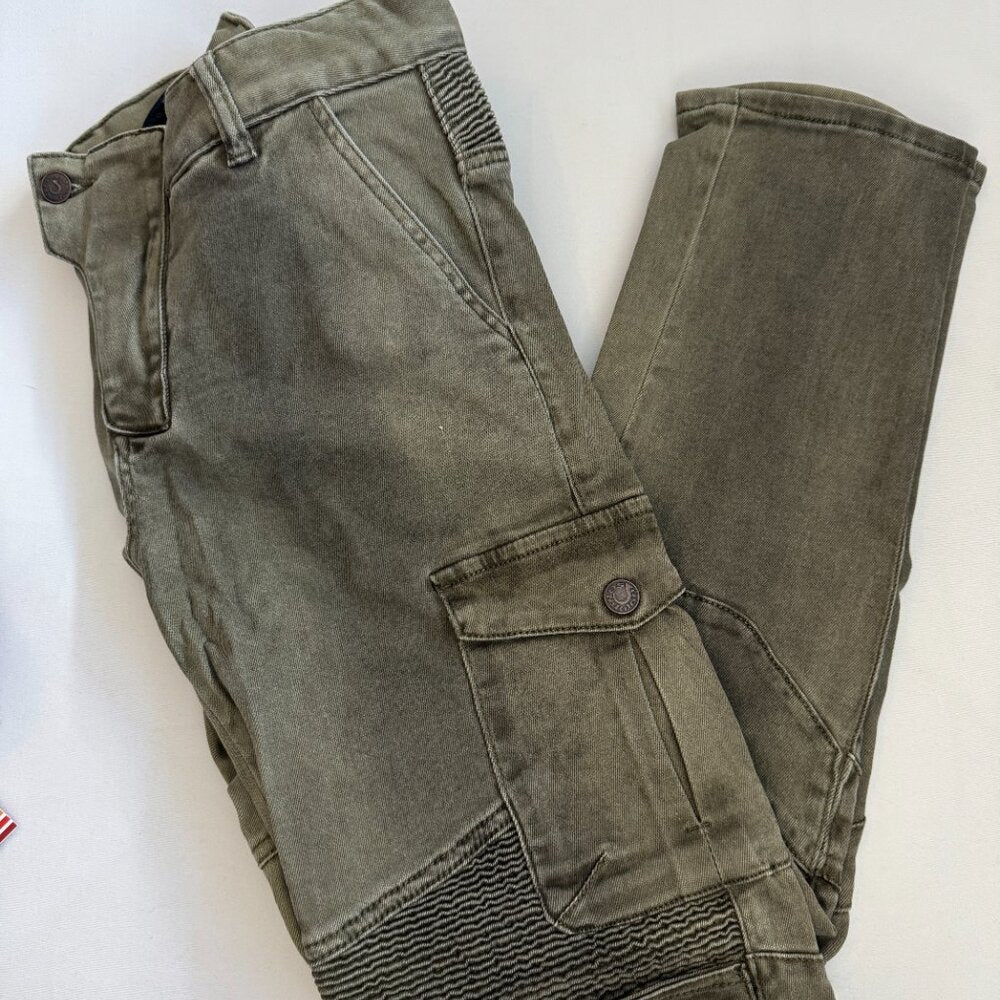 Green jeans laid flat on a white background