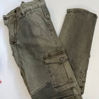 Green jeans laid flat on a white background