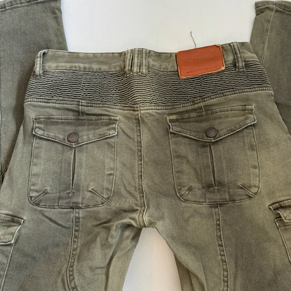 Green jeans with a brown tag on a white background