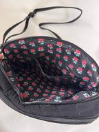 Black bag with red floral pattern on a white background