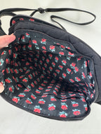 Black bag with red floral pattern on a white background
