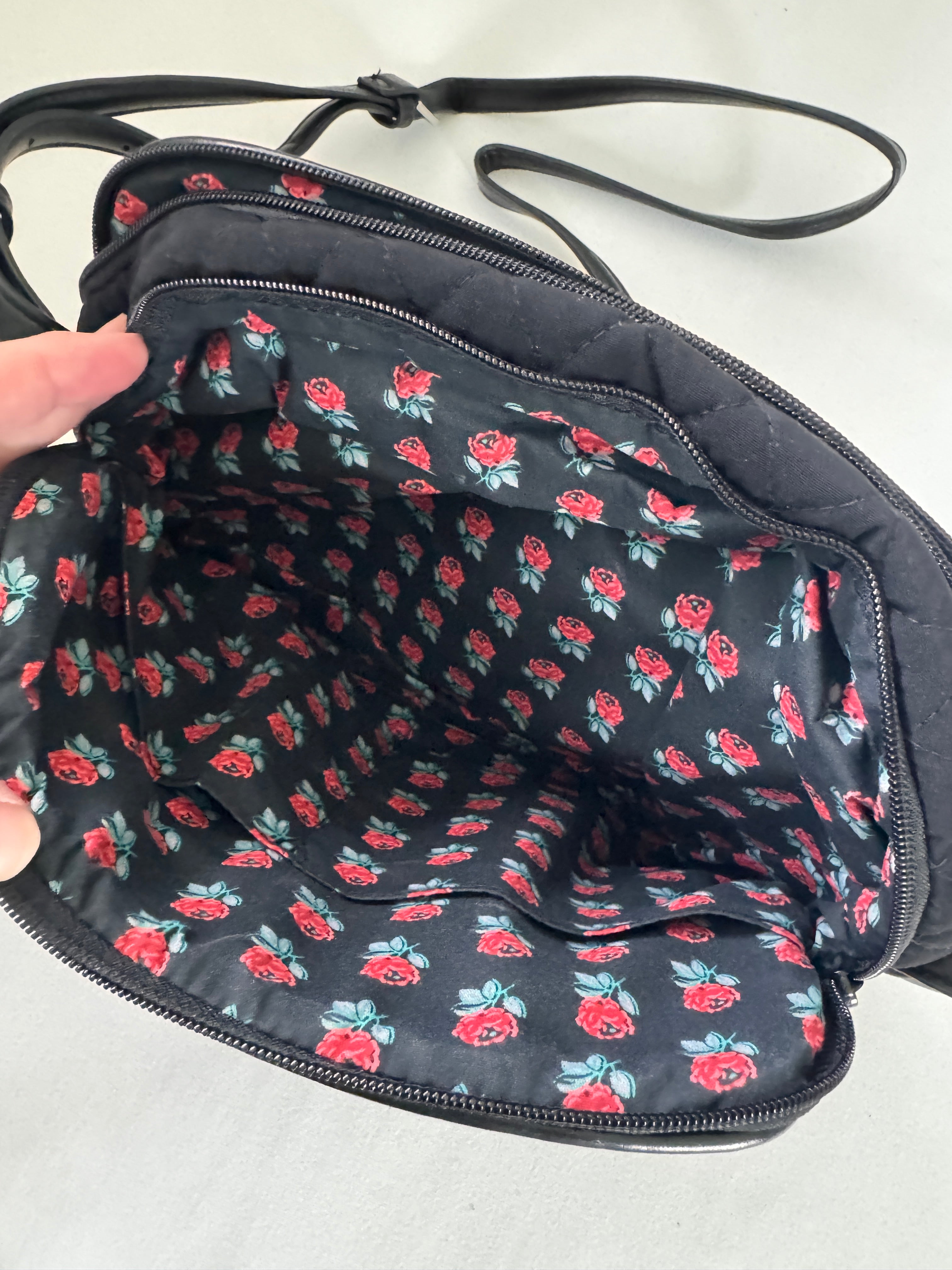 Black bag with red floral pattern on a white background