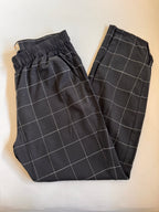 Black checkered pants on a light beige background